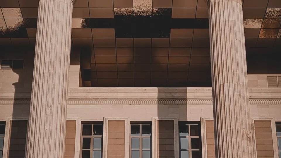 Stone columns framing the entrance of a classical courthouse building.